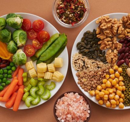 Vibrant display of assorted vegetables, legumes, nuts, and seeds on plates, perfect for healthy eating images.