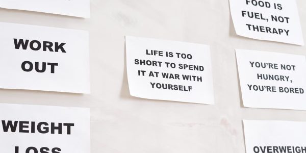 Motivational quotes on white paper promoting healthy habits and lifestyle changes.